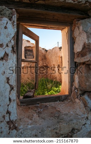 Old opened window of a destroyed house, Elafonisos, Greece