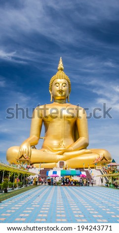 Big Golden Buddha statue shining in the sun and blue sky