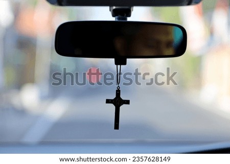 Similar – Image, Stock Photo A rosary hangs from an open Christian prayer book with the Our Father