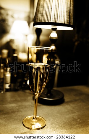 Fairy drink: single champagne glass on bar
