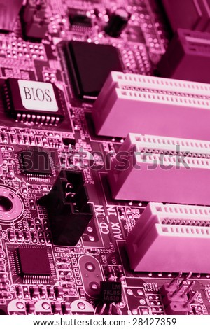 Slots and chips: pink toned motherboard macro shot