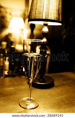 Lonely drinking: single champagne glass on bar
