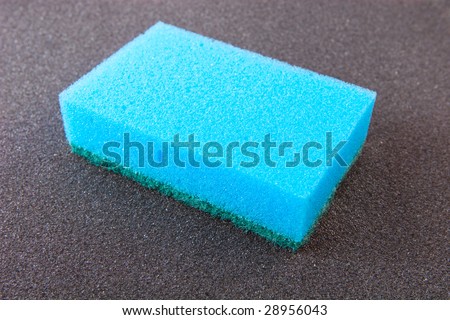 Let's make it clean: blue sponge isolated on grey