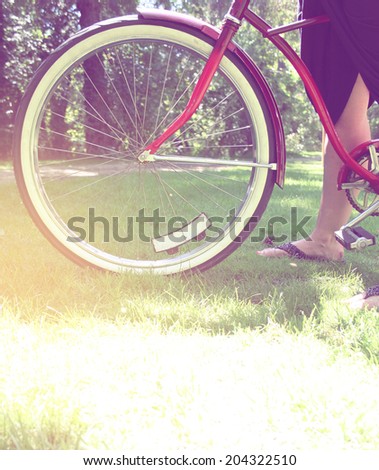 woman standing with classic bike with instagram filter