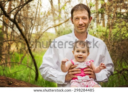 portrait of daddy and daughter in the woods in the summer