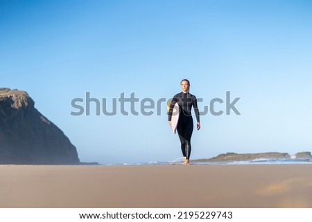 Similar – Image, Stock Photo Surfer woman with wetsuit and surfboard looking at the sea