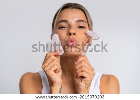 Face massage. Portrait of  beautiful  female fashion model isolated on  white studio background. Blond caucasian woman with healthy well-kept skin. Style and beauty, skin care concept. Foto stock © 