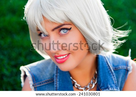 Close up fashion portrait of  sexy woman with big blue magnetic eyes   and short white  stylish  wig  and bright makeup. . Urban stile .