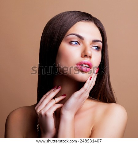 Beauty face portrait with clean and fresh elegant lady. Woman with dark straight hair and sexy lips posing on brown background.