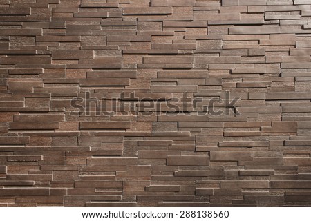 It is Dark  brown brick wall for pattern.