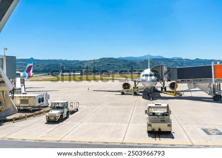 Similar – Image, Stock Photo Airliner plane parked at the terminal view from the front cockpit fuselage, on runway at night