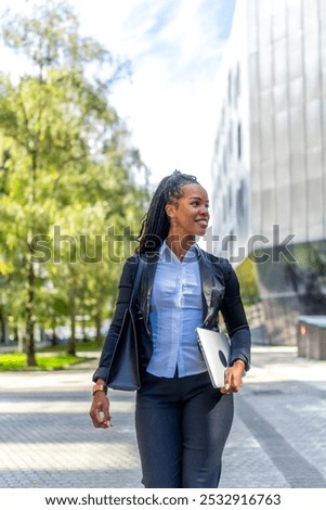 Image, Stock Photo Stylish businesswoman walking along street in city