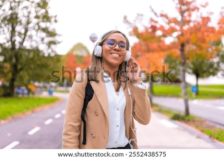 Similar – Image, Stock Photo Stylish businesswoman walking along street in city