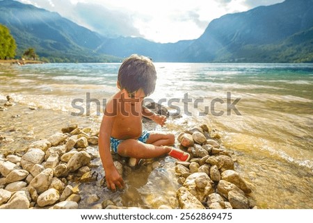 Similar – Image, Stock Photo Rocky mountains surrounding rippling sea under cloudy sky