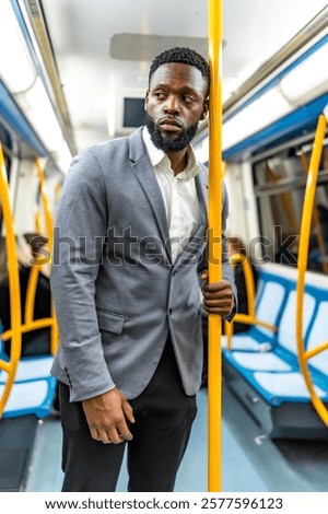 Similar – Foto Bild Nachdenklicher junger männlicher Fahrgast hört Musik in U-Bahn-Wagen