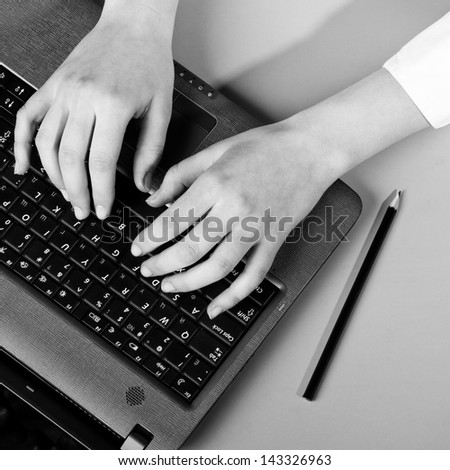 female hands are working on modern laptop, view from above
