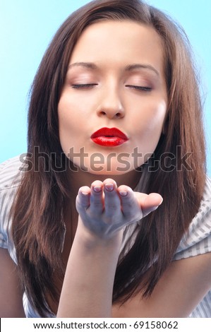 sexy long haired business woman with deep red lips and closed eyes is sending kiss