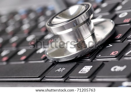stethoscope on the laptop keyboard close up