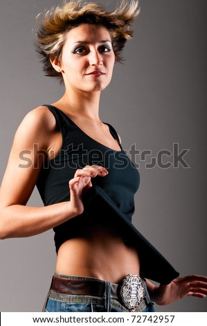 dancing woman wearing black tank top and jeans