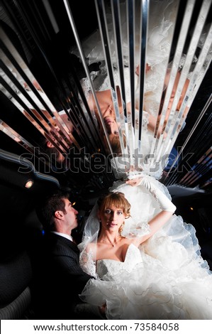 bride and groom at limo with mirror ceiling