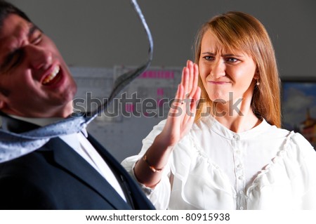 angry businesswoman is slapping across the businessman\'s face