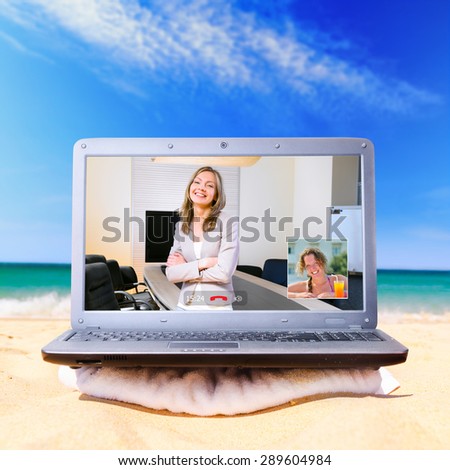 making a video call using laptop on beach
