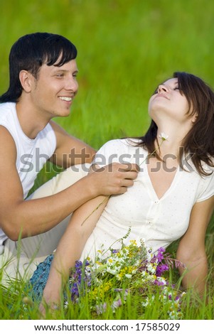 man flirting with woman in field