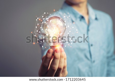 Man holding light bulbs, ideas of new ideas with innovative technology and creativity. concept creativity with bulbs that shine glitter.