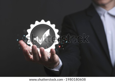 Businessman hand shows the sign of the top service Quality assurance, Guarantee, warranty, Social Responsibility Standard Certified, ISO certification and standardization concept.