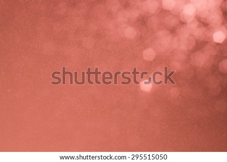 Warm tone background of defocused glittering lights and sparks