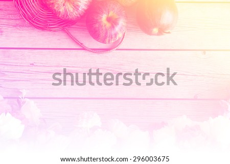 red gala apples with spring fruit tree blossoms on rustic wooden background.