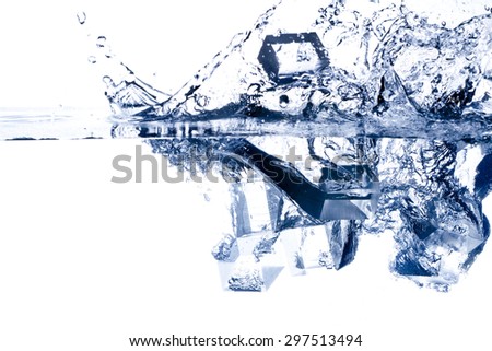 Ice cubes splashing into the water. Isolated on white.