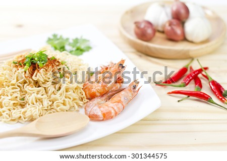Instant noodles food in white on wooden background.