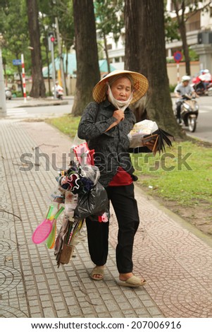 SAIGON, VIETNAM - JUL 15: Unidentified street seller on  Ho Chi Minh City (Saigon), Vietnam on July 15, 2014.