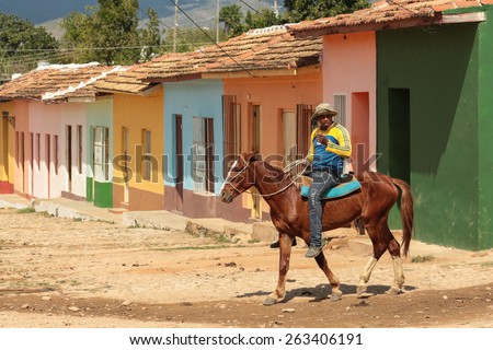 TRINIDAD, CUBA - FEBRUARY 7, 2014 - Man in jeans on a horse in a street in the town of Trinidad, Cuba.