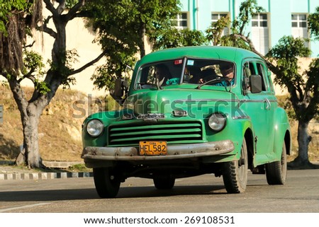 HAVANA, CUBA - JANUARY 2014 - Green classic taxi car in Havana, cuba on the road Photo taken on January 31, 2014