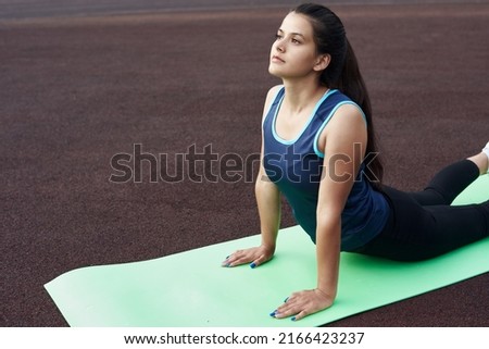 Image, Stock Photo Arab woman doing Upward facing dog asana on embankment
