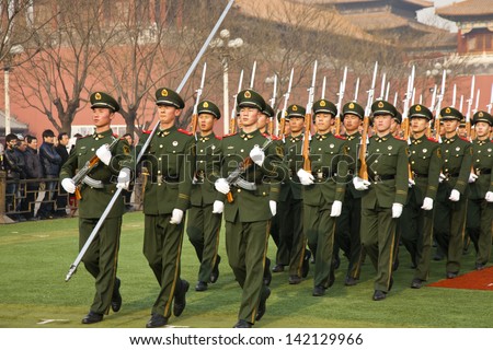 BEIJING - DECEMBER 27: Chinese soldiers are marching training for preparation of the national flag ceremony on December 27, 2011 in Beijing, China. Visitor are watching soldier training.