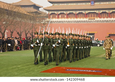 BEIJING - DECEMBER 27: Chinese soldiers are marching training for preparation of the national flag ceremony on December 27, 2011 in Beijing, China. Visitor are watching soldier training.