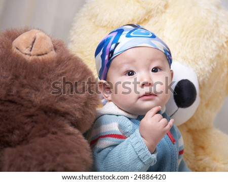 baby and his big teddy bears.