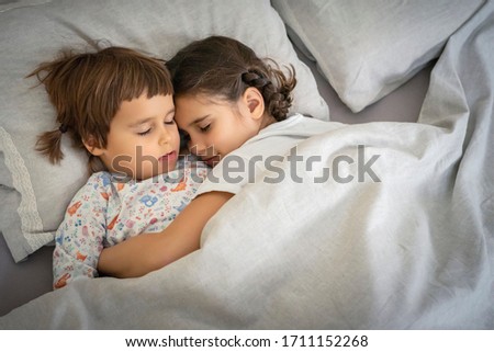 Brother and sister sleeping together