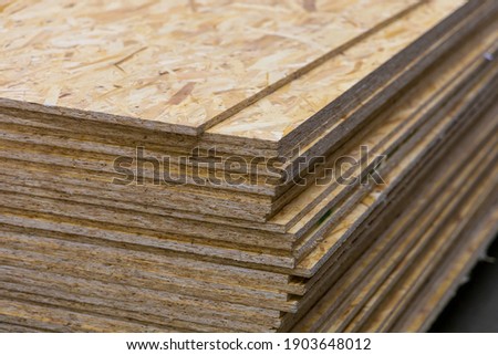 OSB - Oriented Strand Board. Sheet stack in a construction store. Engineered wood product for load-bearing applications in construction Foto d'archivio © 