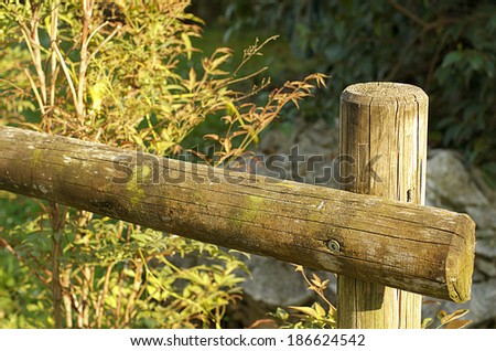 The fence. A simple wooden fence in a public park.
