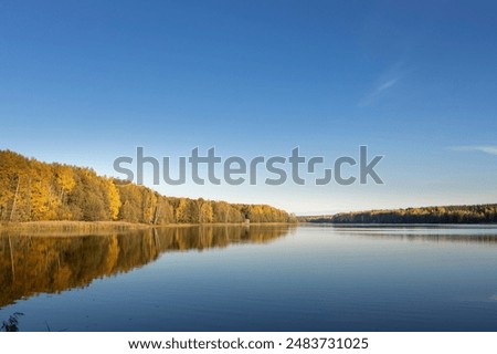 Similar – Foto Bild Ruhiger See, umgeben von Bergen mit Herbstbäumen bei Sonnenuntergang