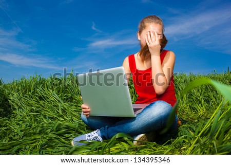 Girl fooling around in the field. Hand on Face