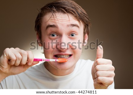 funny young man cleans teeth