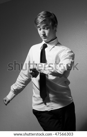 The young man looked at his watch. Black and White