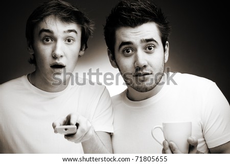 Two young men watching TV. Black And White