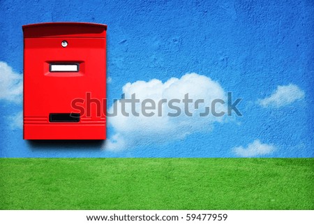 Photo of  red mail box on the wall with landscape