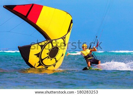 young smiling  kite surfer on tropical sea background Extreme Sport Kite surfing